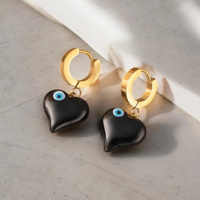 Ατσάλινα κρεμαστά σκουλαρίκια μαύρη καρδιά με ματάκι (E1377) - charmy.gr