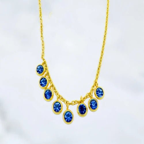 Ατσάλινο κολιέ επιχρυσωμένο με κρεμαστά μπλε ζιργκόν (N3191) - charmy.gr