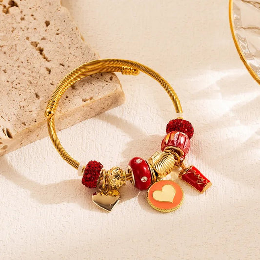 Βραχιόλι ατσάλινο χρώμα χρυσό με καρδιά και διάφορα κρεμαστά (B1392) - bracelet - charmy.gr